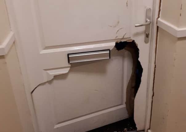 Police broke the door with a ram and climbed through the hole. Picture: Miles Ockwell/Sussex Police