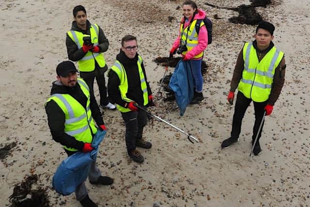Students carrying out a litter pick on East Beach as part of the pilot project. Picture: Stephen Goodger