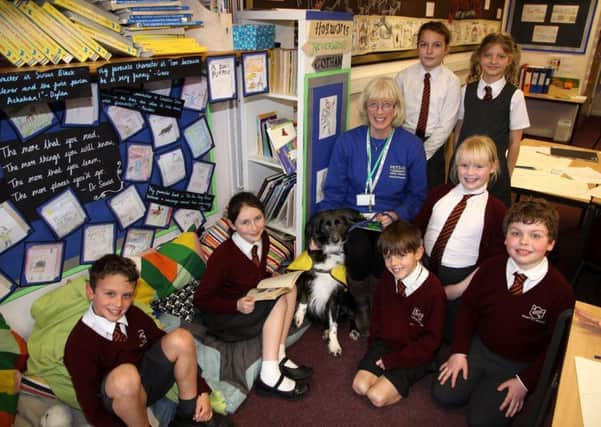 Zacky the reader dog with Pets As Therapy volunteer Nicola Stock and year 4 pupils at Newick CE Primary School. Picture by Ron Hill (HillPhotograpic) SUS-180130-165315001