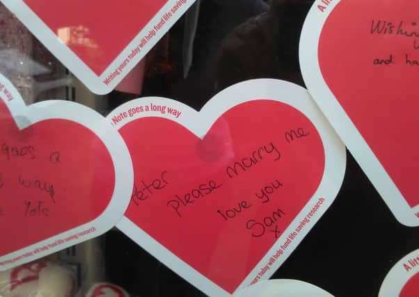 The wedding proposal note left in the window of the British Heart Foundation shop.