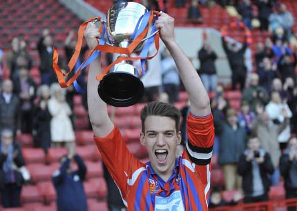 Battle Baptists captain Ollie Jeffs lifts the National Christian Cup at The Valley last May. Picture by Simon Newstead
