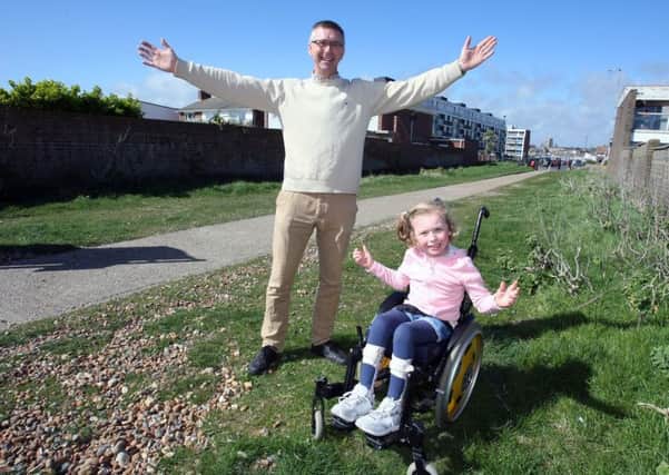 Councillor Ben Stride with his daughter, Darcey, on the footpath to Shoreham Beach
