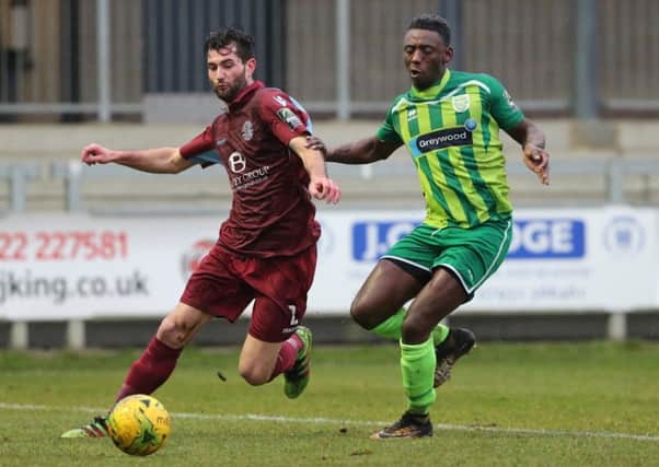 Ollie Rowe holds off an opponent during Hastings United's 4-2 win away to Thamesmead Town last weekend. Picture courtesy Scott White