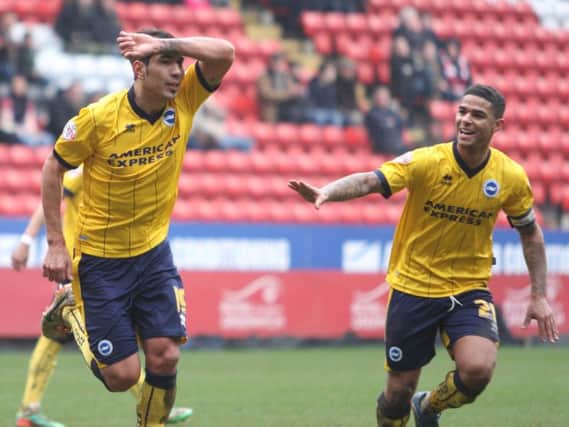 Leonardo Ulloa (left) celebrates a goal with Liam Bridcutt during his time with Brighton. Picture by Angela Brinkhurst