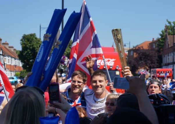 Guy Watts during the Olympic Torch Relay, in 2012, with his brother Thomas and mother Christina