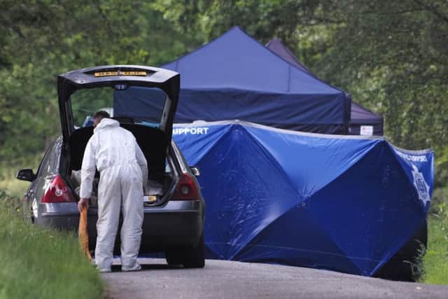 Forensics teams at the site where human remains were found on Hampshire Hill in Slaugham