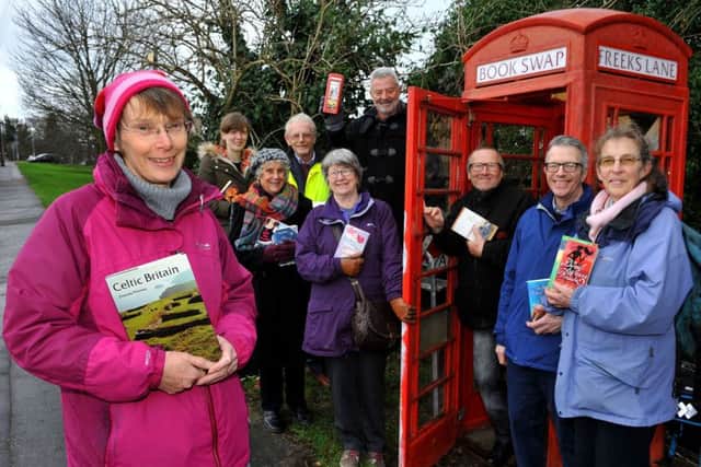 Anne Miles-Eves and other residents who have helped save the telephone box in Freeks Lane. Picture: Steve Robards