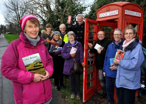 Anne Miles-Eves and other residents who have helped save the telephone box in Freeks Lane. Picture: Steve Robards