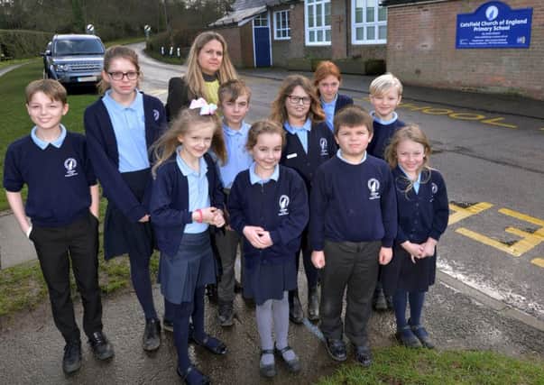 Some of the school children pictured with head teacher Caroline Garland outside Catsfield School