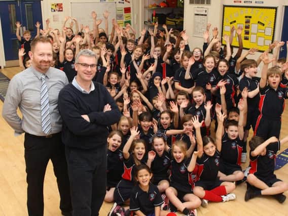 Headteacher Andrew Jolley and deputy headteacher Jez Himsworth, left, with some of the Chesswood children