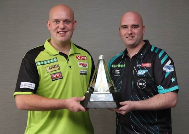 Rob Cross (right) and Michael van Gerwen stand alongside the Unibet Premier League trophy ahead of their opening night showdown in Dublin tonight. Picture courtesy Lawrence Lustig/PDC
