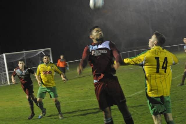 Charlie Bachellier wins a header during the latter stages of Little Common's 3-1 win away to Hailsham Town.