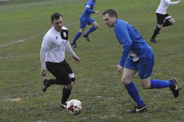 Bexhill full-back Craig Ottley closes down the Storrington player in possession.