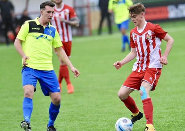 Little Common's man of the match Liam Ward keeps a close eye on the Steyning Town player in possession. Pictures by Stephen Goodger