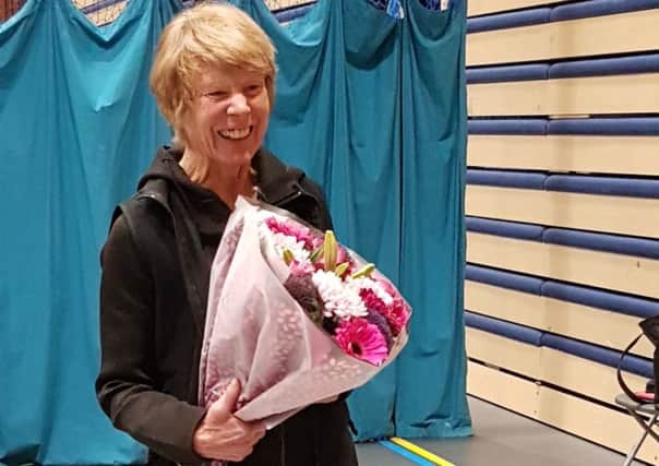 Celia Powis is presented with a bouquet by South Downs Leisure