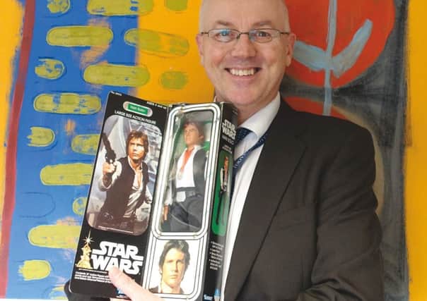 Valuer Christopher Gale from auctioneers Toovey's  with Star Wars Han Solo action figure by Kenner in its original box SUS-180602-111532001