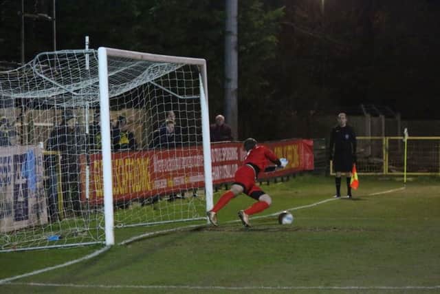 Pagham goalkeeper James Binfield saves Scott Kirkwood's penalty. Picture by John Lines