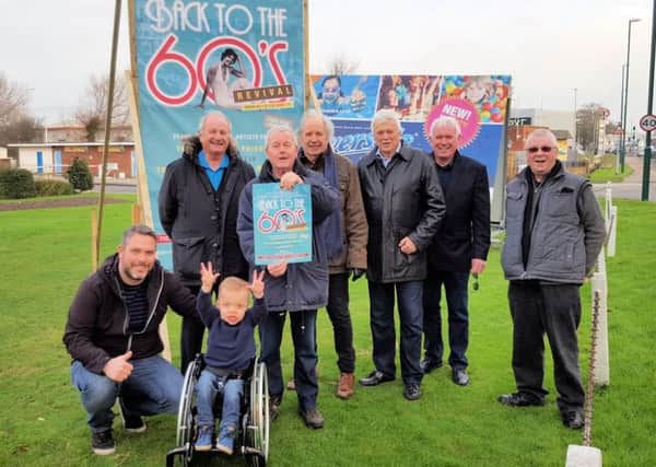 Some of the musicians with Charlie and his dad Jamie Fielding, beside the billboard for Back to the 60s Revival at the Riverside ballroom