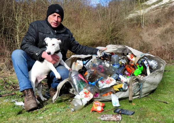 Jan Antonowicz with his dog Nobby on Highdown Hill with the litter he had collected. Picture: Kate Shemilt