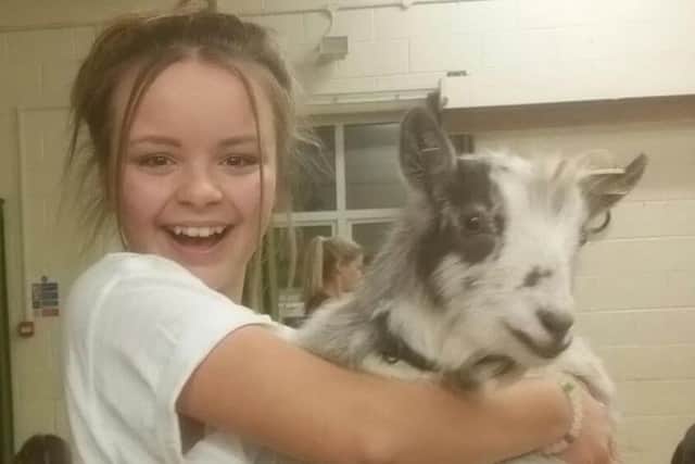 Emily Twinn-Dorey, 12, from Wick Farm Road, Littlehampton, with a goat she befriended while doing goat yoga