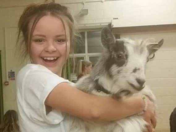 Emily Twinn-Dorey, 12, from Wick Farm Road, Littlehampton, with a goat she befriended while doing goat yoga
