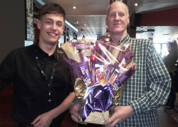 The replacement chocolate bouquet presented by Paul Gunn from Grandpa's pick "N" mix, right, with Joe Peacock at The Three Fishes