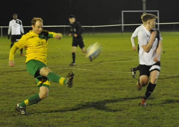 Bexhill United midfielder Liam Foster turns his head as a Hailsham Town plays the ball forward at The Polegrove last night. Pictures by Simon Newstead