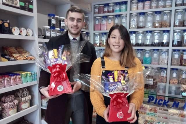 Sophia Douglas presents kitchen manager Josh Jones with two chocolate bouquets at The Sweet Shack