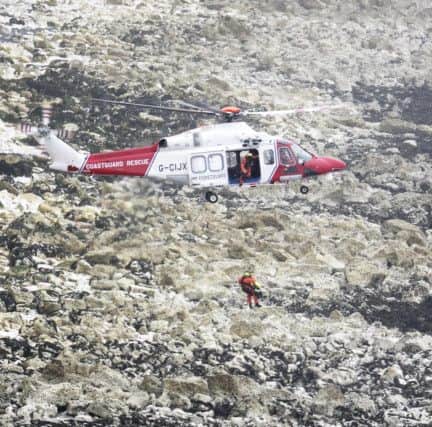 A member of the coastguard rescue team was injured and airlifted to safety