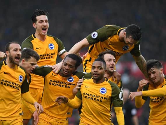 Lewis Dunk celebrates Jose Izquierdo's goal with his Albion team-mates. Picture by Phil Westlake (PW Sporting Photography)