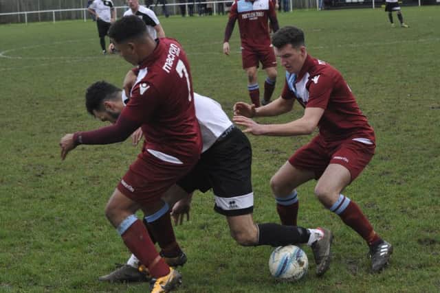 Liam Ward and Wes Tate tussle for possession against Bexhill United on Boxing Day.