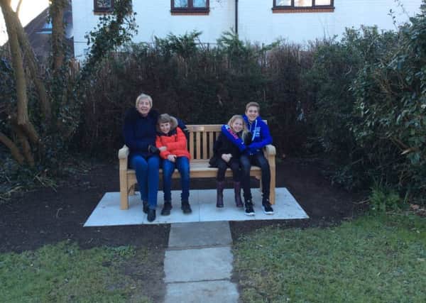 Lin Curnock and her three grandchildren. A bench in memory of her late husband Malcolm has been unveiled in Broadbridge Heath (photo submitted).