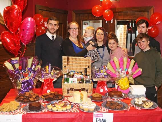Staff and customers with the Valentine's Day cake sale and hamper raffle for CLIC Sargent following a theft at The Three Fishes, Worthing. Photo by Derek Martin DM1822029a