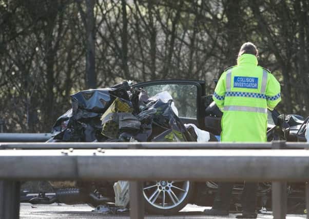 Police at the scene of the crash on the M23.