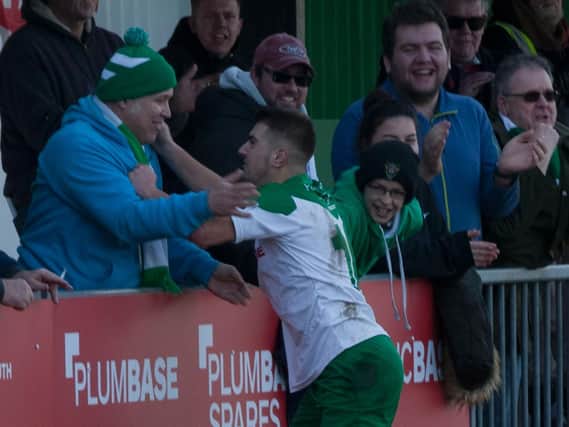 Ollie Pearce celebrates with the fans after scoring in his first start following three months out injured / Picture by Tommy McMillan