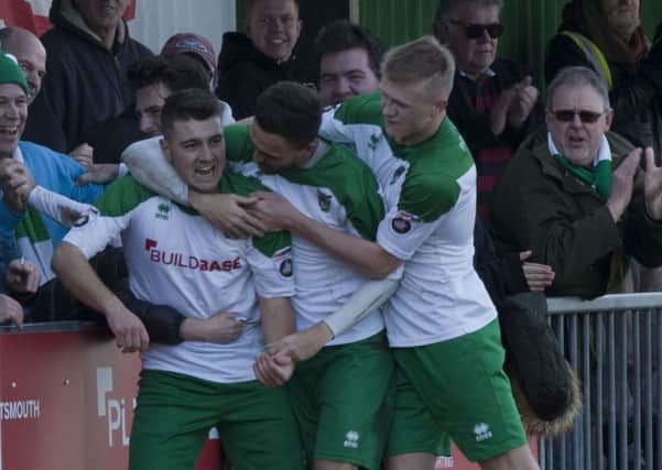 Ollie Pearce is mobbed after his comeback goal / Picture by Tommy McMillan