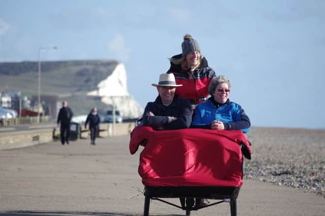 Leisurely ride in the sunshine ... the trushaw takes two passengers along Seaford seafront