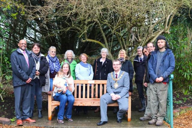 Jo Hooper, Highdown Gardens manager, and mayor Alex Harman on the new bench, with staff, volunteers and councillors