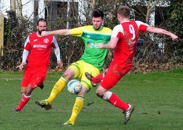 Jamie Gravett tussles for possession during Westfield's 3-1 defeat at Bosham on Saturday. Pictures by Kate Shemilt