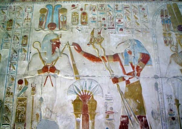 Ancient Egyptian magic in action: the beaky ibis-headed god Thoth presents life and renewed kingly power to the deceased pharaoh Seti the First, in a carved and painted scene in Setis temple at Abydos in Egypt.
Picture by Mick Oakey SUS-180221-092710001