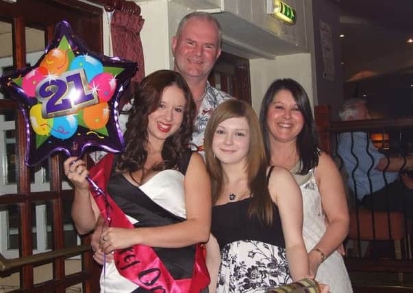 Kerry Harvey (left) with her mum Eileen (right) and her dad and sister Amy on her 21st birthday