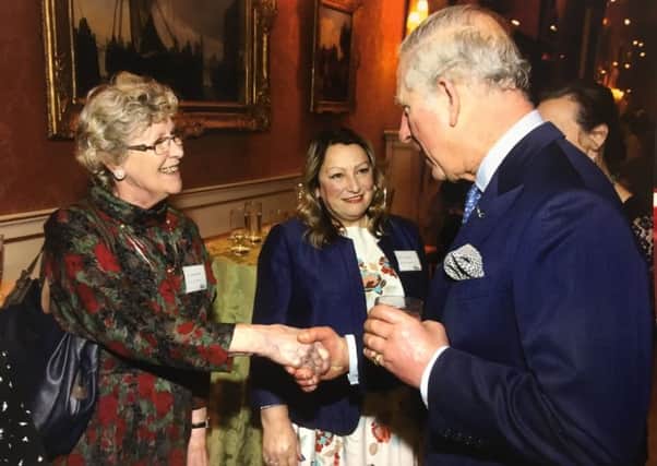Terri Ashpool and Pam Goldsmith from Billingshurst Macmillan Group with HRH The Prince of Wales at Buckingham Palace SUS-180221-124849001
