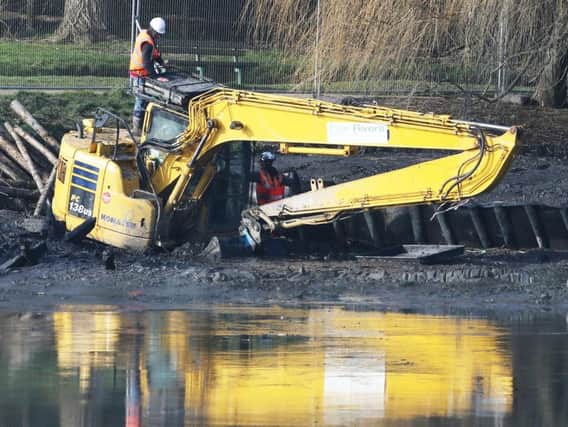 A digger appears to be sinking in Brooklands Lake. Picture taken at 10am on February 21. Picture: Eddie Mitchell
