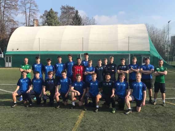 Staff and players of Worthing College's men's football performance programme line-up ahead of a training session in Italy