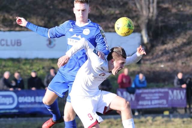 Calum Davies challenges for an aerial ball against Hythe Town. Picture courtesy Scott White