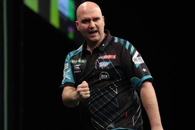 Rob Cross celebrates a successful shot at the Mercedes-Benz Arena. Picture courtesy Lawrence Lustig/PDC