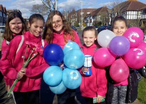 Girl Guides Jessica Townson, Charlotte Blunsdon, Sarah-Jane Holden, Evie Austin and Evie Cuthbert offered balloons and flowers to young donors along the way