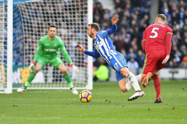 Glenn Murray goes down under Mike van der Hoorn's challenge to win Brighton & Hove Albion a penalty. Picture by PW Sporting Photography