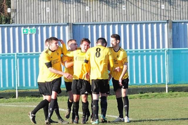 Golds celebrate Stephen Herbert's goal in the win at promotion-chasing Chichester City. Picture by Kate Shemilt KS180080