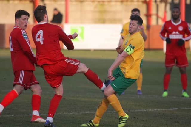 Hythe's Town's Chris Kinnear was sent off for this tackle on Horsham's Scott Kirkwood. Picture by John Lines